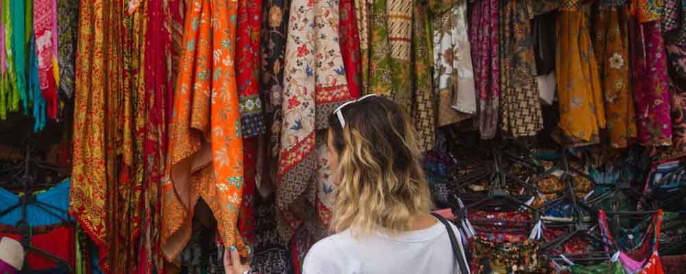 Woman looking at scarves at a market